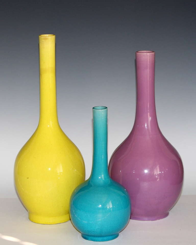 Kyoto pottery vases in brilliant turquoise and yellow glazes and Awaji bottle vase in pink glaze.