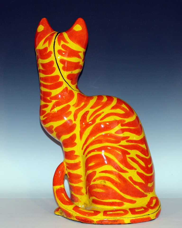 Vintage large Italian pottery cat figure, circa 1960s. Smartly modeled form of a cat seated motionlessly, but at high alert with penetrating gaze and ears pricked forward waiting for next move. Glazed in striking yellow and orange with dark blue or