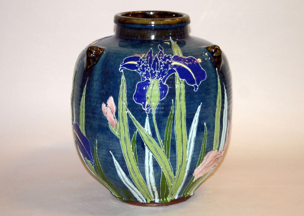 Traditional Japanese Shigaraki storage vessel painted in thick enamels with blue and pink irises. Impressed and painted studio marks.