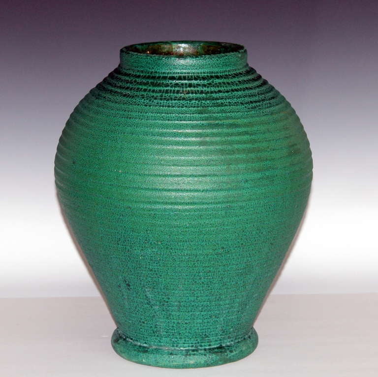 Large and rare Merrimac Arts & Crafts vase, circa 1905. In full bodied form with clearly defined ribs, flared foot, and terrific matte,  moss, alligatored green glaze. 15