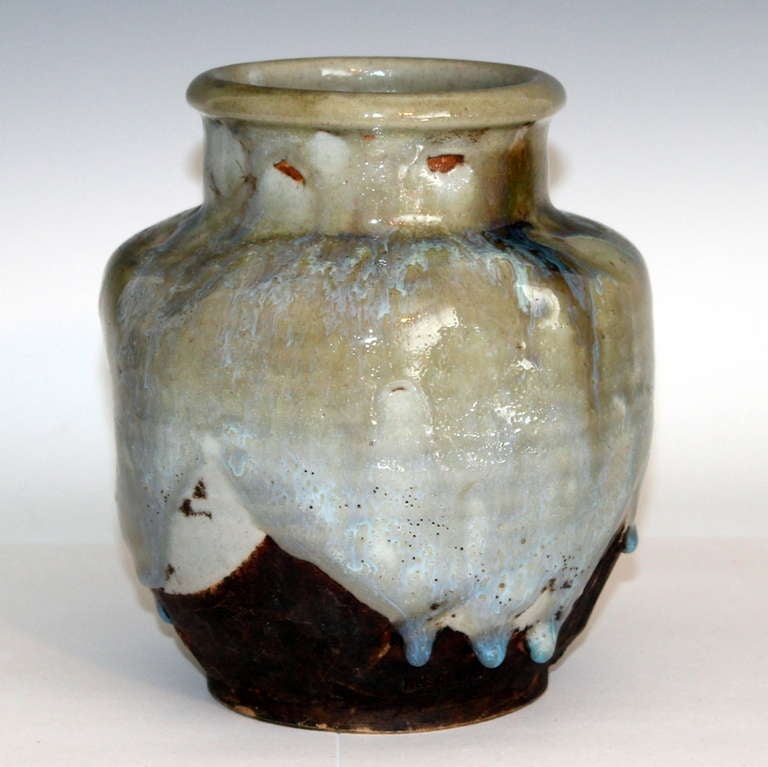 Awaji Pottery vase with gouged and dented body. And thick flambe drip glaze suspended just above the footrim. The flambe has been caught in incipient state, just as it began to flash in the kiln, and has left the glaze mostly translucent to a very