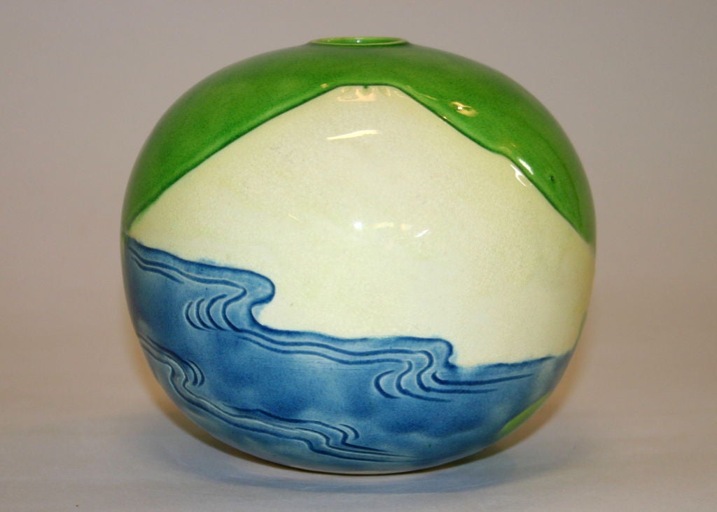 Spherical vase with incised image of a mountain above the ocean against a vibrant lime green ground. Impressed Kiln mark. Very special early piece.