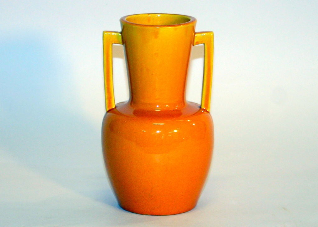 Awaji pottery vase with pair of squared handles and covered in warm yellow glaze.
