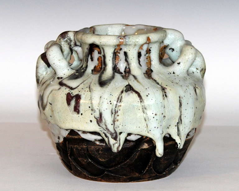 Awaji pottery vase with crossed loop handles at the shoulder and thick, frothy shino drip glaze suspended just above the base.