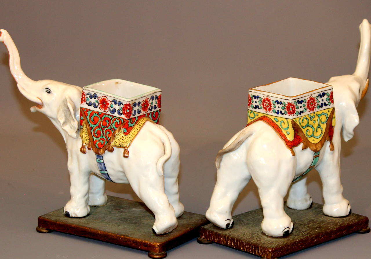 Pair of antique Samson porcelain elephant potpourri container garniture figures in Japanese Kakiemon style, circa 1890s, with Marny, Paris gilt bronze stands. Measures: 8" high, 9" wide, 3" deep. One trunk restored, stands with gold