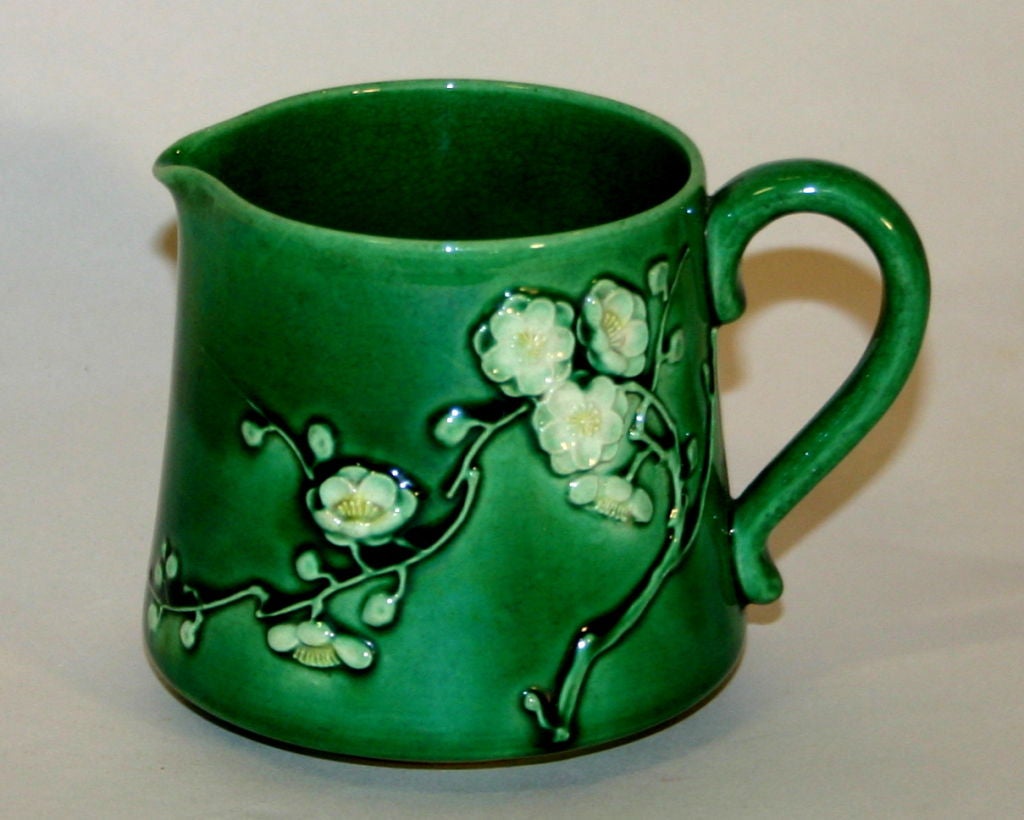 Awaji creamer in forest green glaze with delightful spray of hand applied plum or cherry blossoms. Minpei kiln. Impressed plover mark.