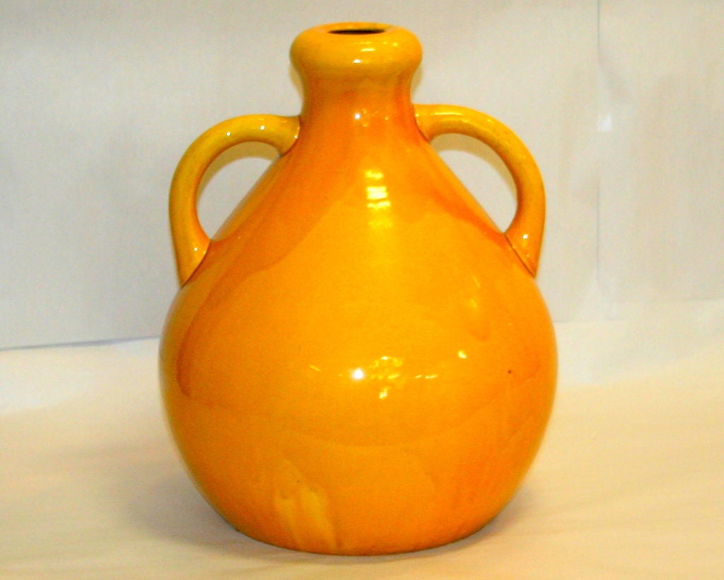 Large, warm yellow Burmantofts pottery vase in organic form with garlic neck and applied handles. Impressed Burmantofts cipher.