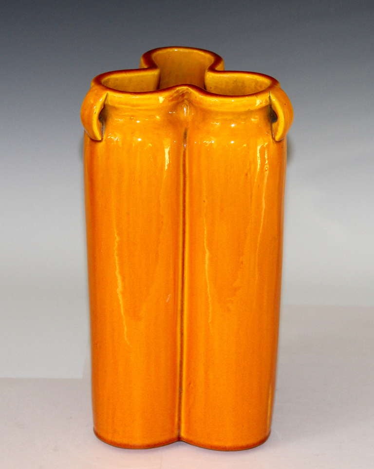 Awaji pottery vase in triple lobed form with slightly indented neck and three little lug handles with warm, amber yellow glaze.