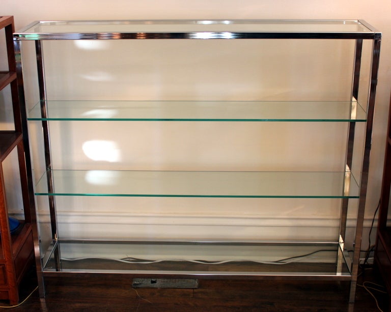 Minimalist chrome frame with heavy glass shelves. 44