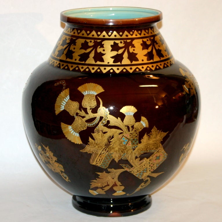 Monumental Sarreguemines art pottery vase elaborately gilded with thistles, an ancient symbol of nobility, in two-tone leaf and 