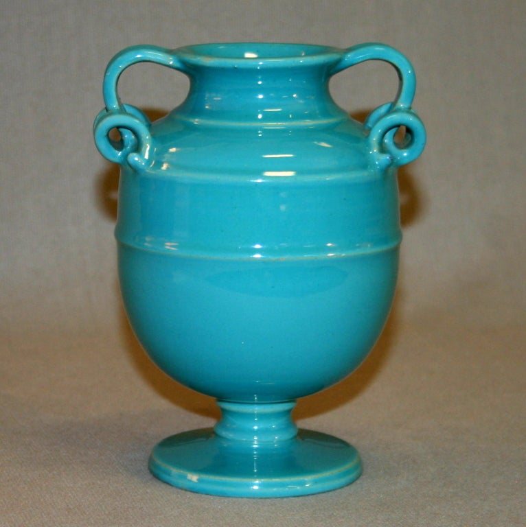 Cantagalli pottery vase in light turquoise glaze with delicate, split curly cue handles.