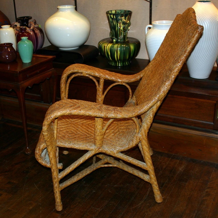 Large, vintage wicker lounge chair with bamboo framing, generous proportions, and great sweeping lines from the French Colonial period in Vietnam. Measures: 44