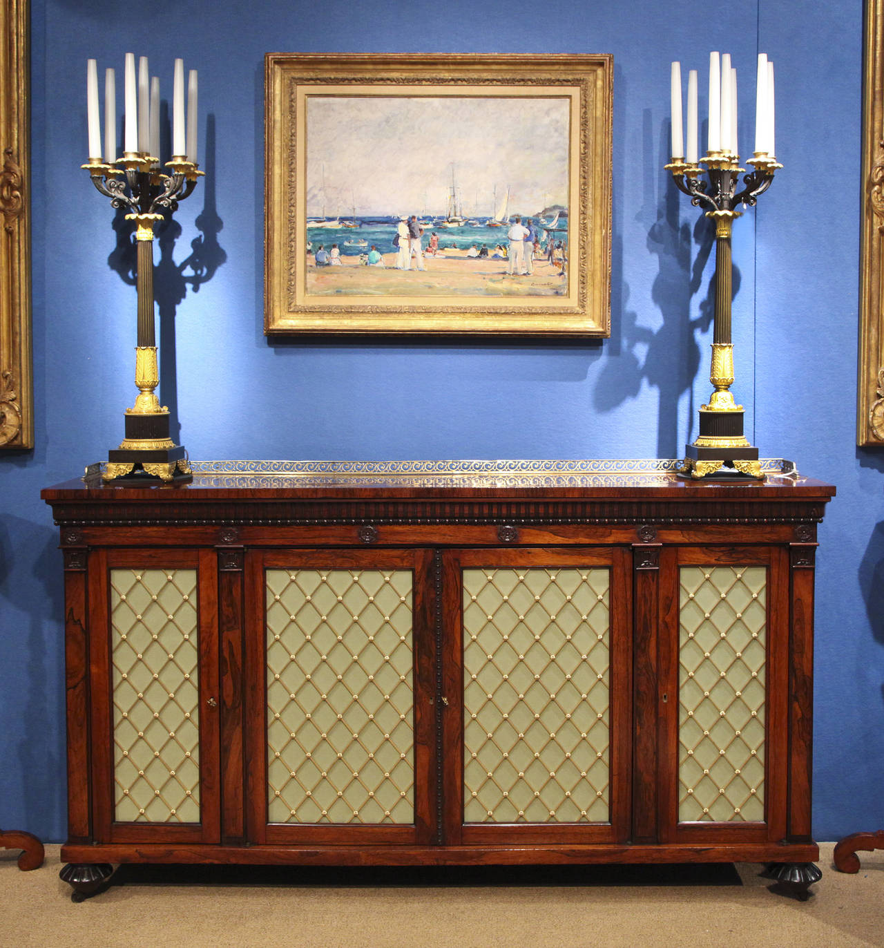 No. 5032 - Fine William IV period carved figured rosewood credenza, having a finely figured rectangular top with 3/4 pierced brass Vitruvian scroll gallery above reeding and bead carving and having five carved applied flower heads to the frieze,