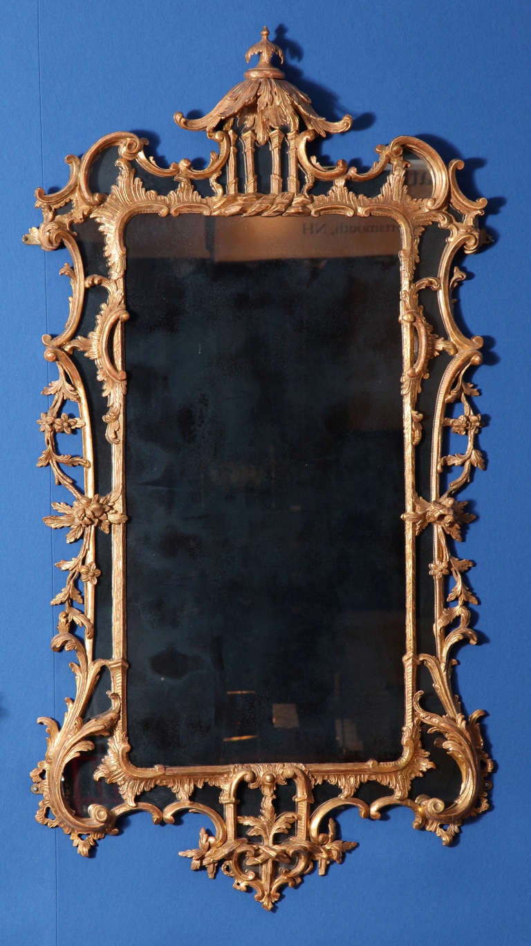 Fine Chinese Chippendale Carved and Giltwood Border Glass Mirror, having a leaf carved pagoda cresting and finial above four moulded columns and rockwork, with 