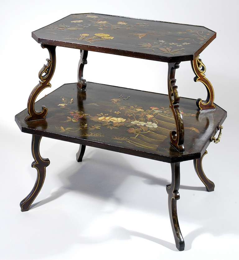 Fine Antique French Two-Tier Japonaserie Decorated Espresso Colored Gilt Flecked Lacquer Table, with flowering branches and birds in a watery landscape. c. 1870. This table is very similar in form and decoration to a table illustrated in 