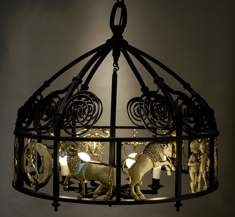 Very Fine hand crafted vintage wrought iron and brass six light domed chandelier with intricate scroll designs in wrought iron centering a band of three dimensional cast brass figures of the zodiac, electrified.  American c.1950