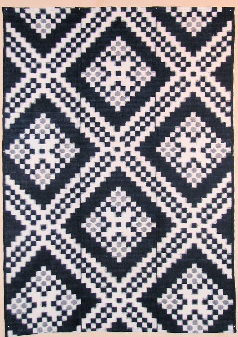 Early 20th century Japanese cotton ikat futon cover with squares in indigo and white and gray/blue circles all in a repeated pattern of squares that form almost an op-art pattern.