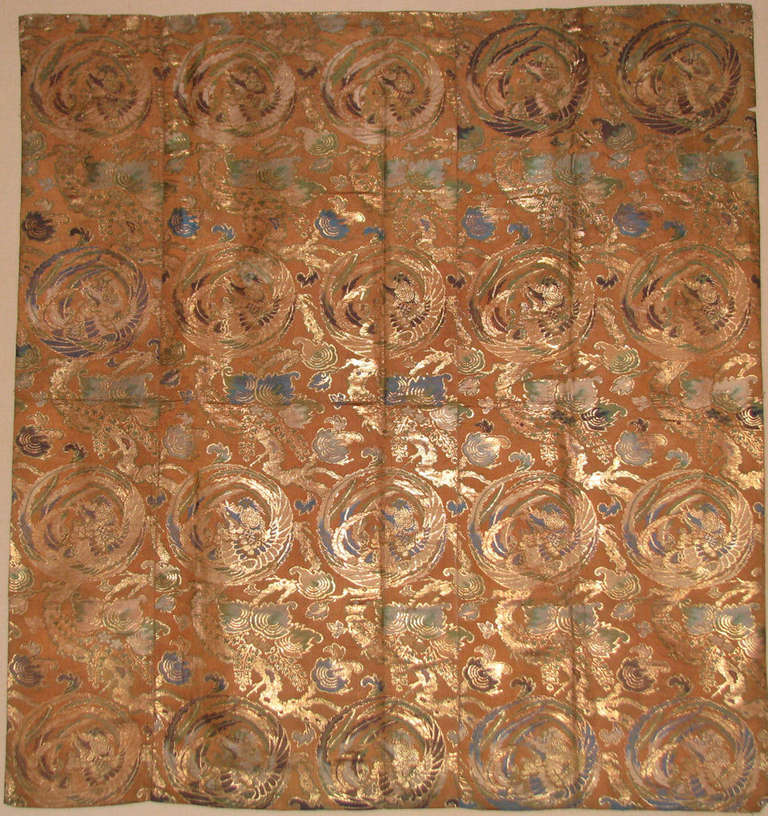 Last quarter of the 19th century (Meiji) Japanese silk brocade temple hanging with a bronze colored ground figured with a repeated concentric dragon/phoenix design.  Temple dedication on the back.