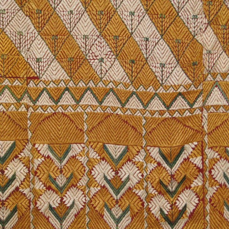 Silk floss embroidery on cotton from India called a phulkari, embroidered in white and gold diagonal bands in a geometric design with green centers. Phulkari, translation 