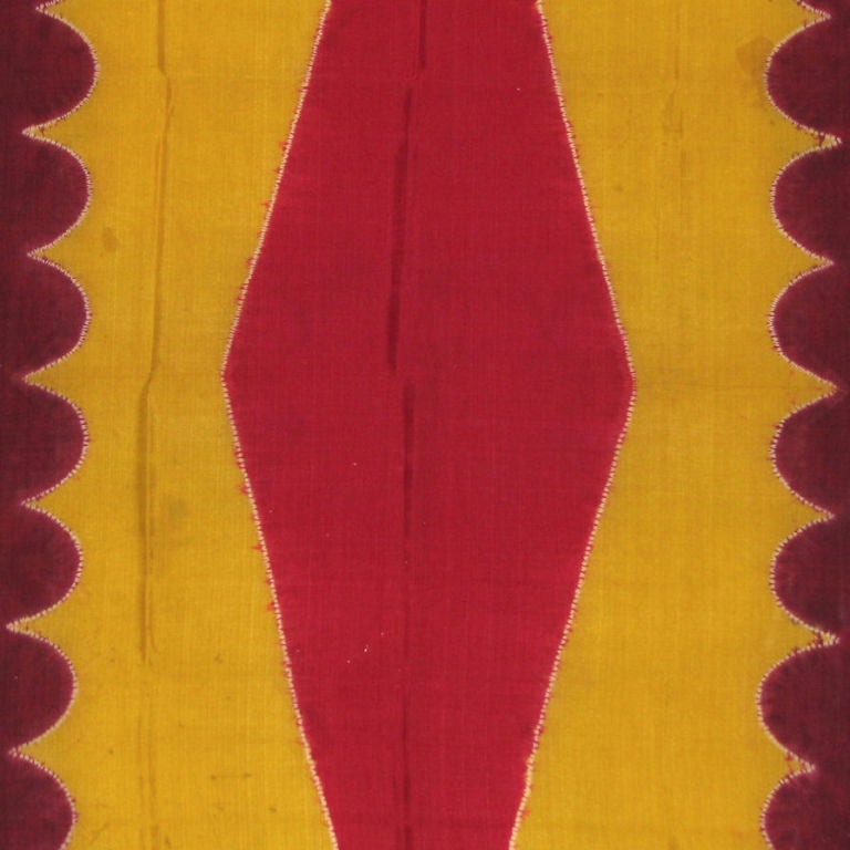 A late 19th century Indonesian (Sumatra) ceremonial presentation scarf (lawon) worn by a married woman. This multi-colored silk cloth was resist dyed in a process called plangi or pelangi, literally meaning “rainbow”. The edges are purple with a