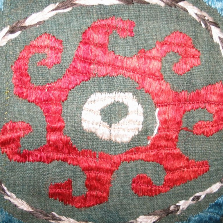 A late 18th century silk embroidered panel on a green cotton ground called a 