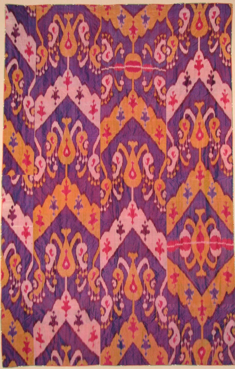 Early 20th century silk Ikat panel, Central Asia, Uzbekistan, Samarkand or Fergana Valley; in shades of crimson red, yellow, purple, blue, burgundy and white. Large-scale pattern with large abstract motifs.