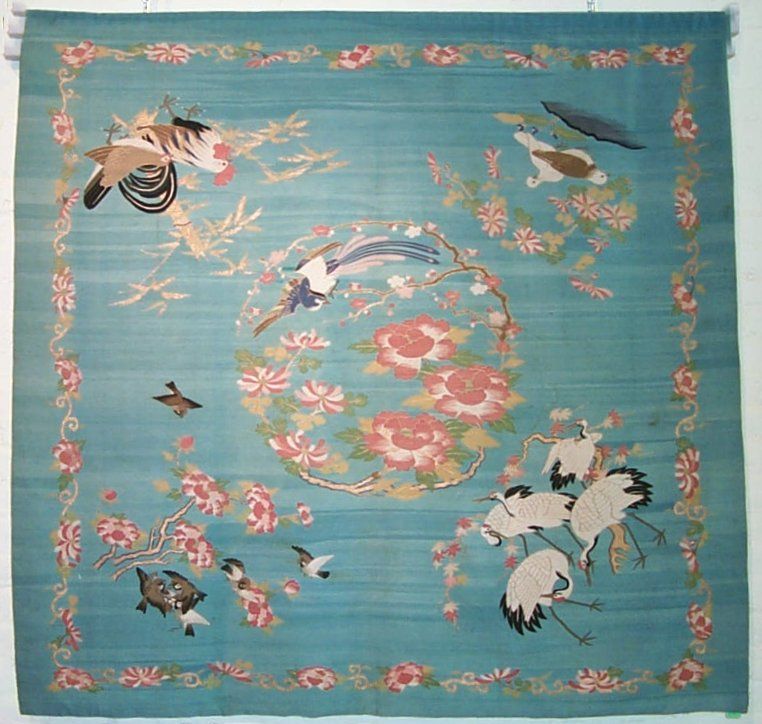 Japanese blue ground k'oss-u (tsuzure-ori) with central roundel of mums, peonies and prunus branches with bird of paradise. This was probably used as a wedding gift cover.
