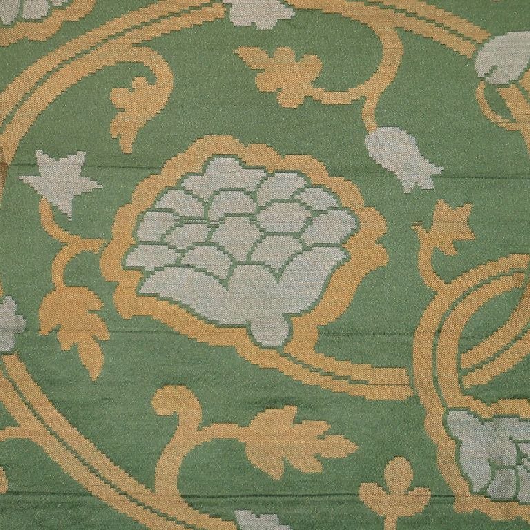 A French green and yellow silk brocatelle with an Ottoman inspired design of stylized pine cones and flower heads.