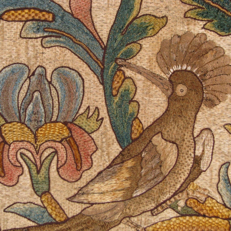 Late 17th century Italian silk floss laid work panel (one of a pair) decorated with images of pairs of exotic birds amidst foliated vines and large flower heads including two sunflowers embroidered with large French knot centers.