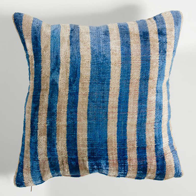 Blue and white striped pillow with a slight sheen and long pile.