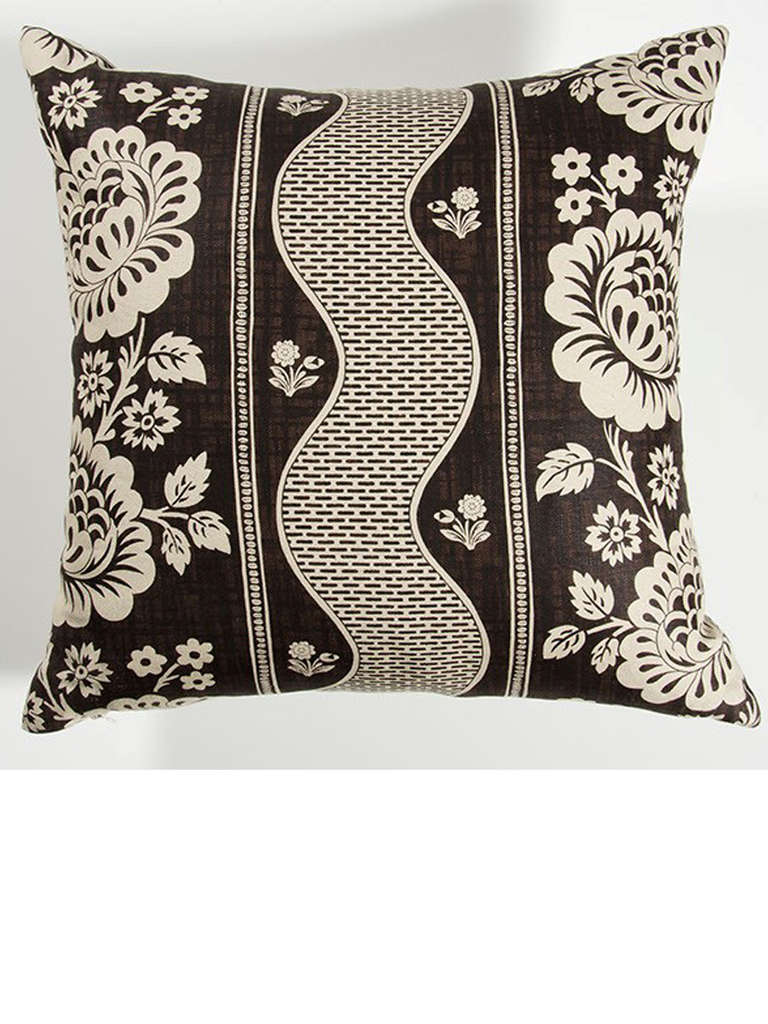 Brown and white floral patterned pillow made from Rosa Bernal fabric.