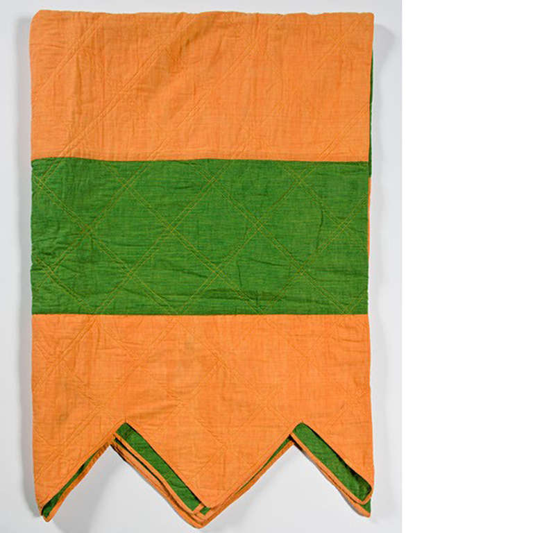 An Italian made cotton bedcover in orange and green.