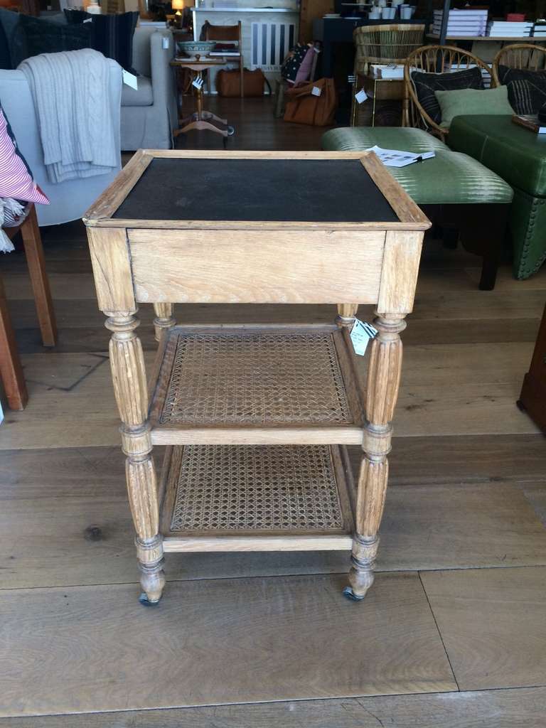Three tiered cane side table on castors.
19th c. France.