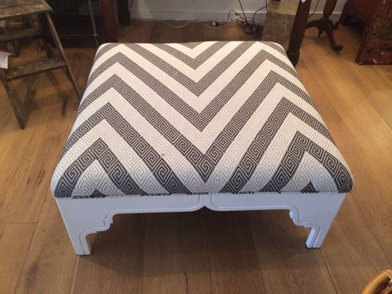 Large white based ottoman with black and white greek key fabric.
