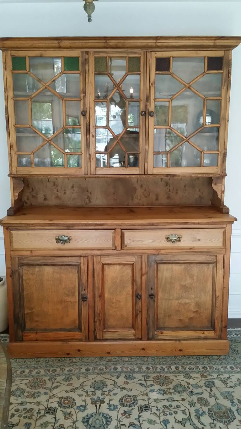 A beautiful 19th C English Pine Buffet with stained glass details.