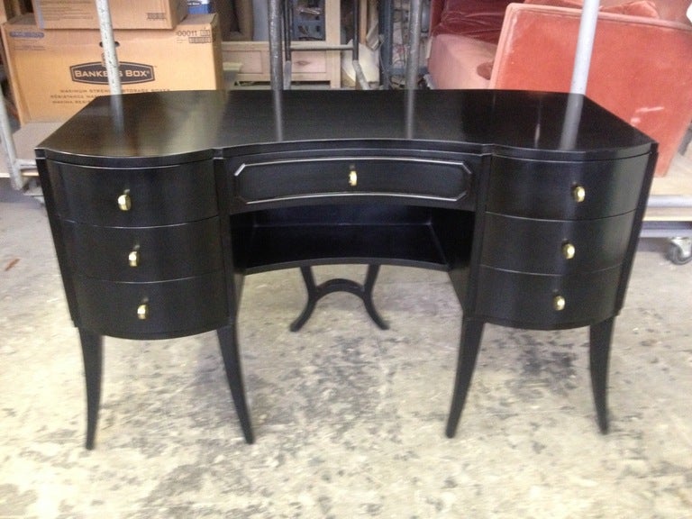Vintage French Art Deco small vanity/writing desk with curved legs and round pale brass hardware.

If you would like to see this piece in person, please call us to schedule a viewing.