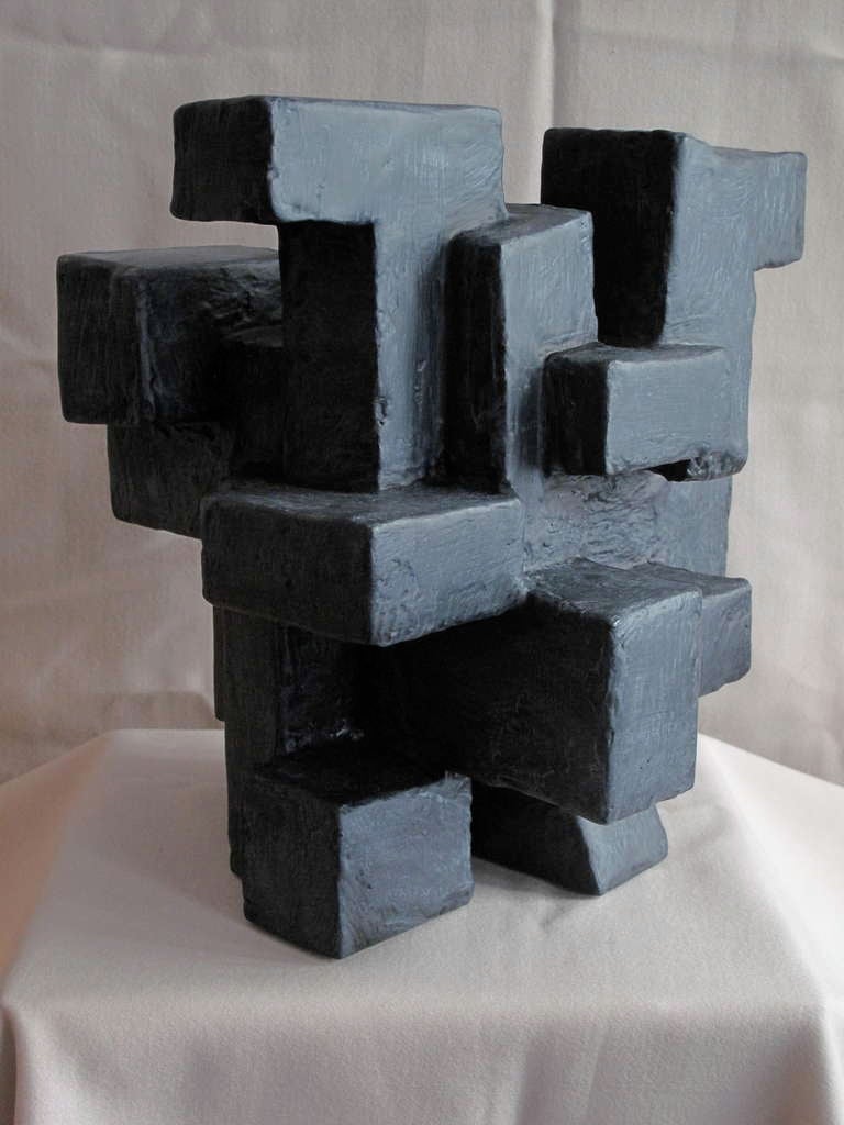 Dan Schneiger free standing sculpture.

Monolithic in form and constructed largely of reclaimed materials such as found wood,salvaged fiber board, plaster and paint, these bold and graphic sculptures call to mind mid-century influences ranging