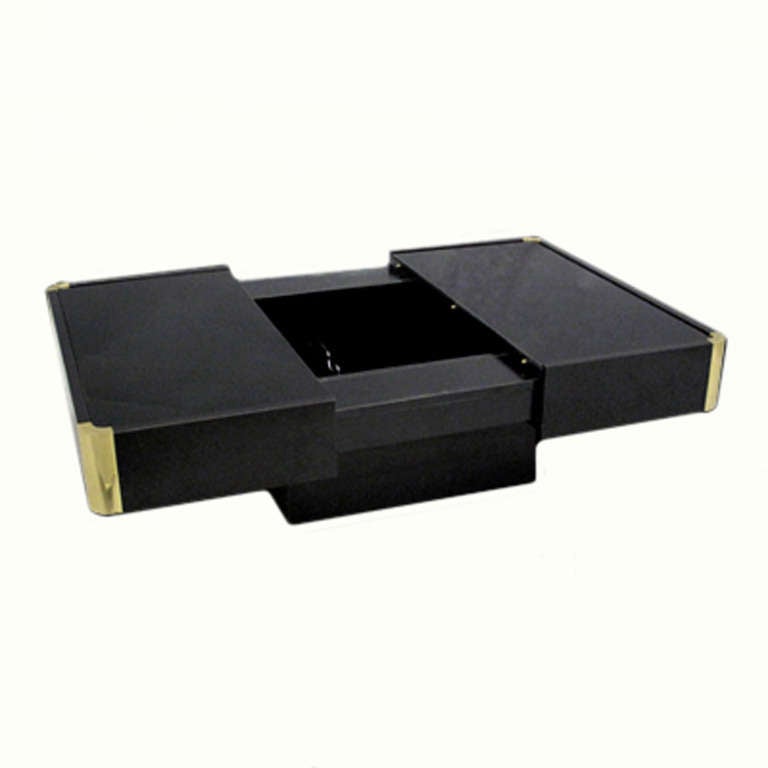 1970's vintage black lacquered coffee table with hidden bar compartment and rounded brass corners.