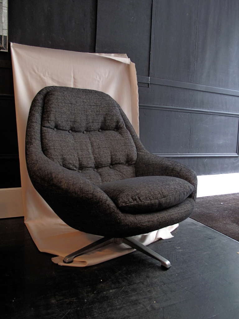Vintage Danish modern swivel armchair on metal legs upholstered in a brown textured fabric.
