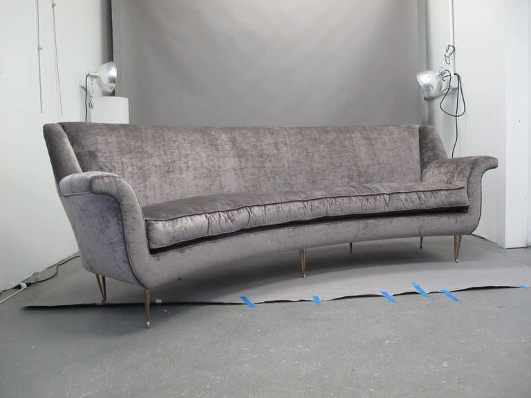 Vintage curved back sofa with rolled arms on brass legs newly upholstered in grey velvet. Italy, 1960's.