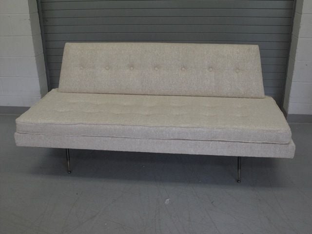 1950's Italian armless sofa with button tufted casion and back-tapered legs with original brass sabots. Newly reupholstered.