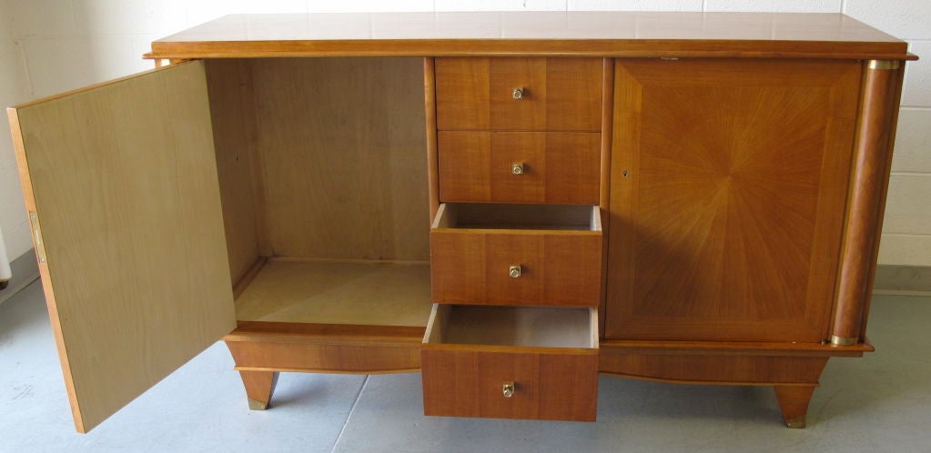 1940's Italian cherry wood side board with two sunburst marquetry inlay doors flanking four central drawers. Decorative diamond marquetry columns capped with brass bands.