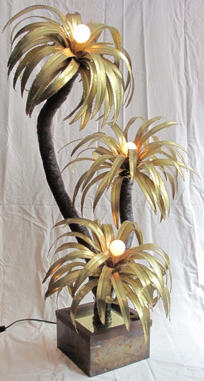 1970's French brass palm tree floor lamp in the style of Curtis Jere. On original wood and brass base, newly rewired.