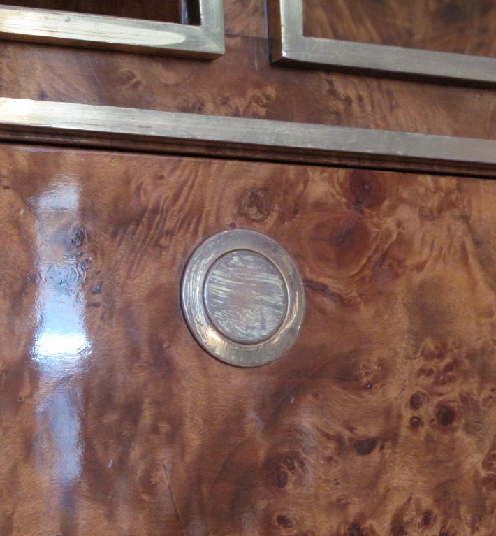 1970's French burlwood bookcase and cabinet with brass trim and hardware. In two pieces.<br />
<br />
<br />
As this piece may be in our off-site storage, please call ahead to schedule a viewing.