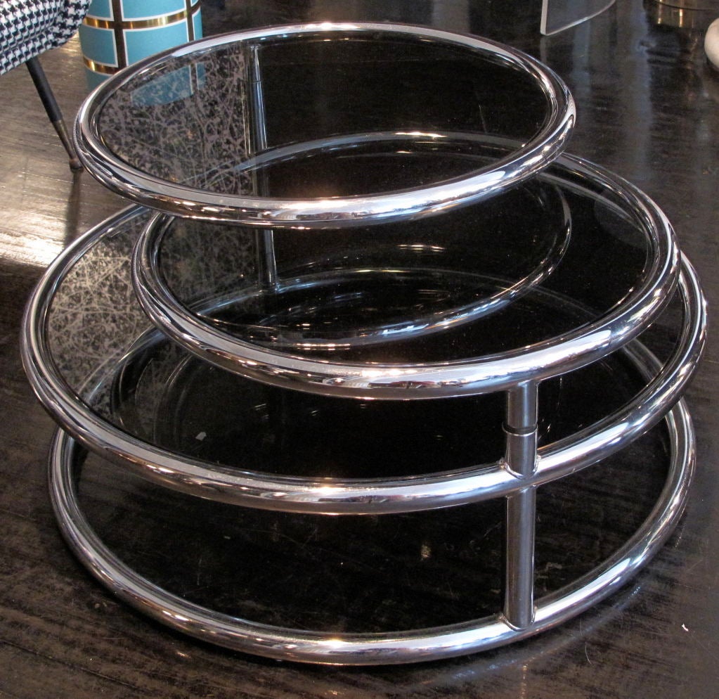 Vintage American glass and chrome coffee table with three swivel plateaus.