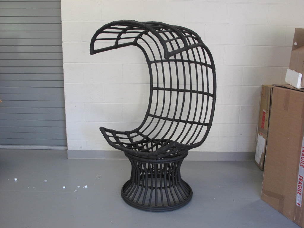 Pair of vintage Italian rattan concierge chair with a matte black finish. Priced as a pair; available individually.<br />
<br />
As this piece may be in our off-site storage, please call ahead to schedule a viewing.