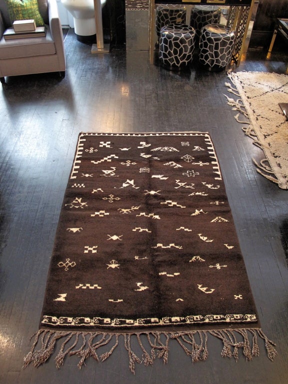 Vintage Moroccan Beni Ourain rug in a dark brown with white symbols.