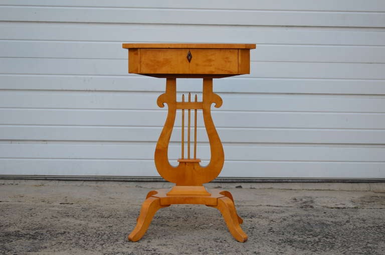Magnificent period Karl Johan (Biedermeier) lyre shaped pedestal base table. Originally handcrafted as a sewing table, today it makes a wonderful end or side table with drawer.