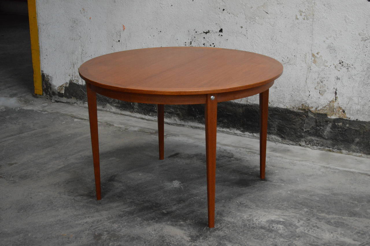 Mid-Century Modern round Swedish teak dining table.