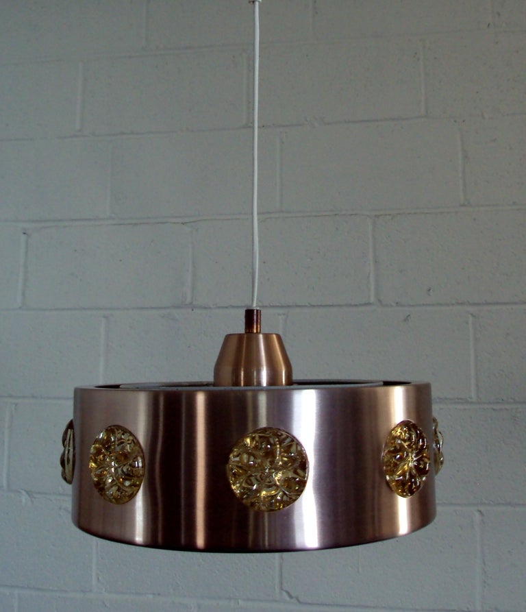 Copper tinted brushed spun aluminum pendant with golden champagne colored glass medallions. Newly rewired to US standards.